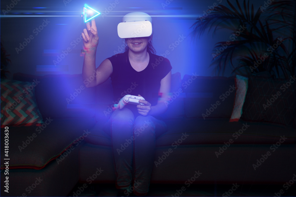 Fototapeta premium Woman playing game at home using vr headset