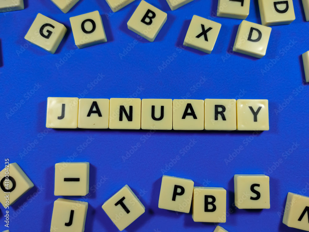 Obraz premium Alphabets on blue background with text JANUARY.