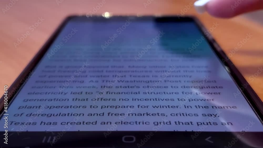 Finger with white nails scrolling through mobile device (cellphone) Finger with white nails scrolling through mobile device (cellphone)