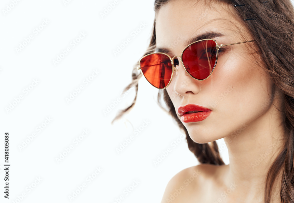 Elegant brunette lady in brown glasses on a light background Elegant brunette lady in brown glasses on a light background