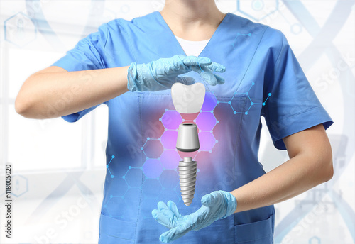 Obraz na plátně Dentist with digital model of tooth implant in clinic
