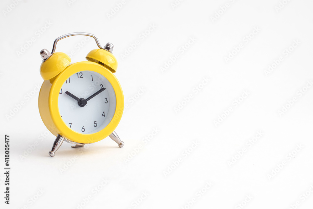 Small yellow alarm clock with bell isolated on white background. Small yellow alarm clock with bell isolated on white background.