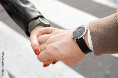 Young couple holding hands outdoors