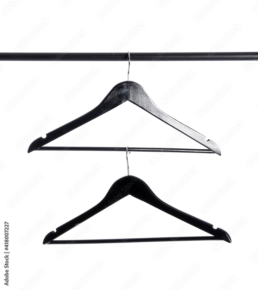 Clothes hangers on rack against white background Clothes hangers on rack against white background