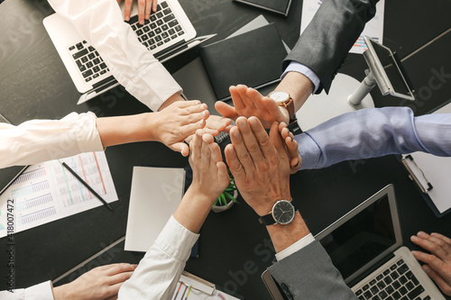 Business team hands stacked...