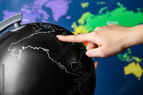 Female hand with globe on w...