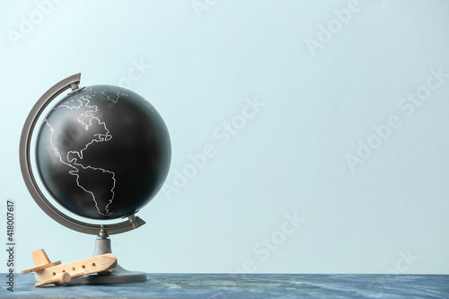 Globe with wooden airplane ...