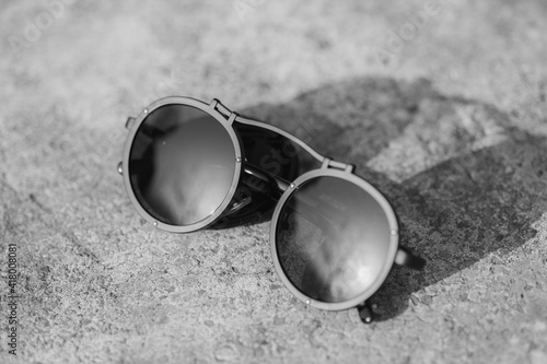 Steampunk model sunglasses with big round lens shoot outside in a summer day closeup. Selective Focus. High quality photo