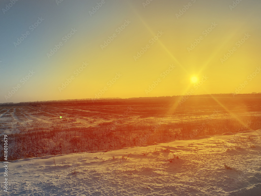 Sun over winter field