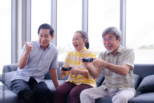 grandma enjoy playing game console with her retired friends