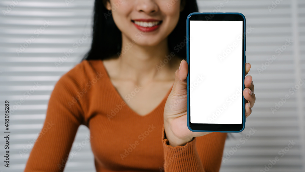 Mock up mobile blank white screen on hands of Asian woman while sitting.