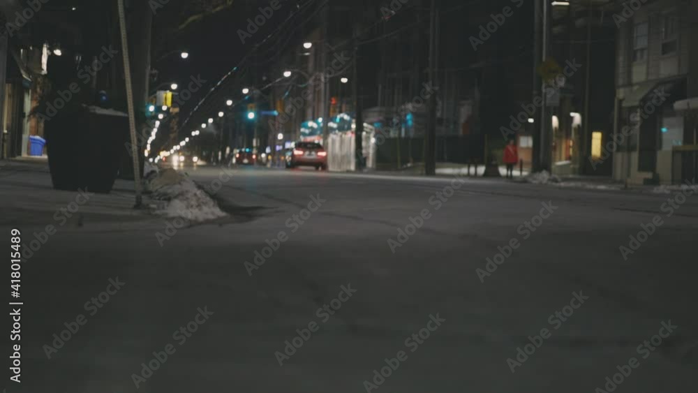 Cars Driving In Quiet Street At Night. low level, static shot Cars Driving In Quiet Street At Night. low level, static shot