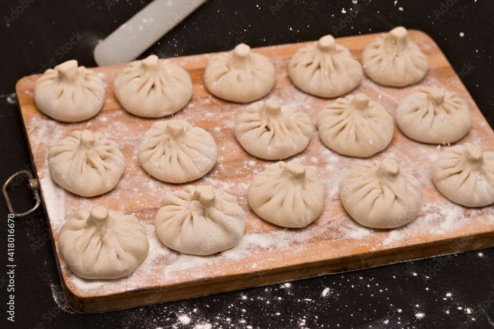 Symmetrical rows of uncooked Georgian khinkali Symmetrical rows of uncooked Georgian khinkali