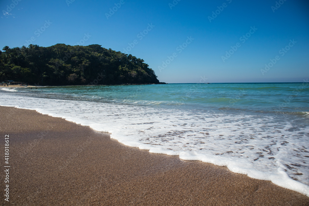Waves breaking on the beach of the Pacific Ocean in Lo de Marcos, Riviera Nayarit, Mexico.