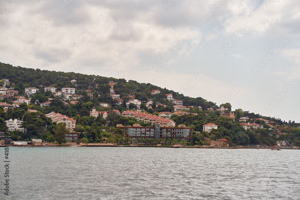 Island shoreline with buildings and trees view from water