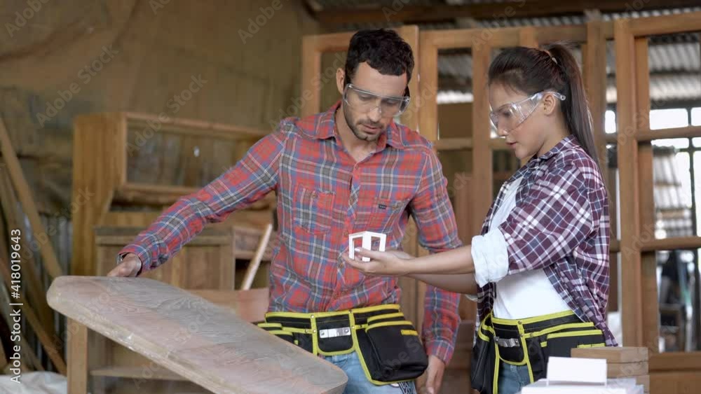 carpenter workers man and woman discussing to design the handcrafted ...
