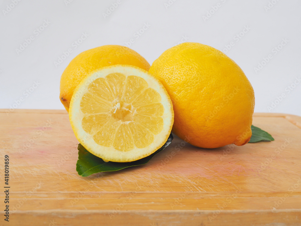 Closed up to slice lemons on the wooden cutting board Closed up to slice lemons on the wooden cutting board