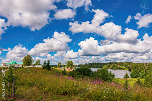 Large and curly clouds on a sunny day over the Holy Trinity Alexander Svirsky Monastery. Holy Trinity Alexander Svirsky Monastery in the Leningrad region, known for architectural monuments.