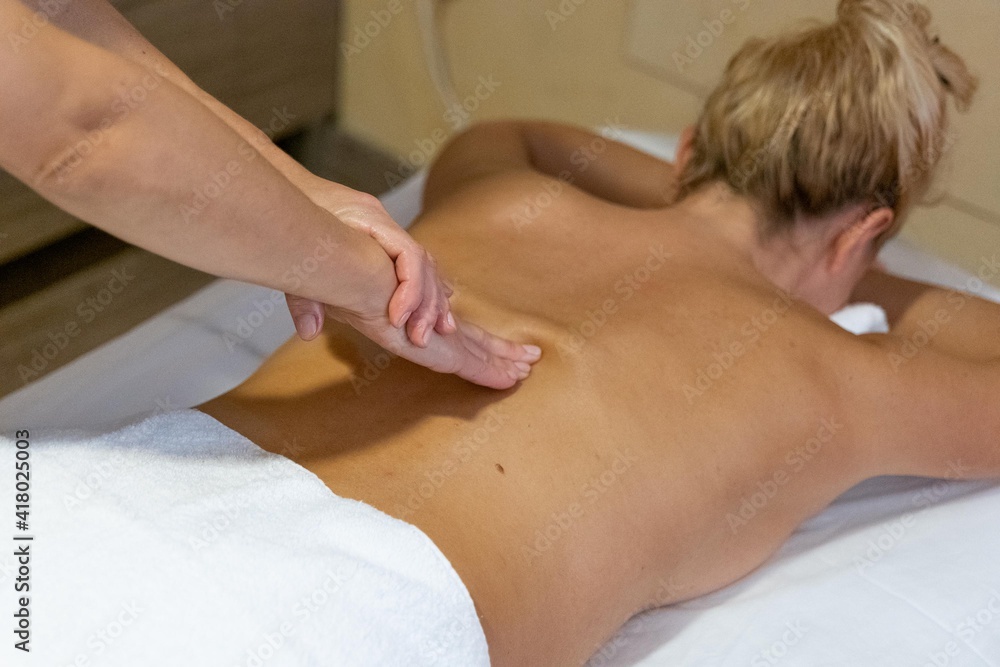 Fototapeta premium Chiromassage therapist giving a back massage to a client