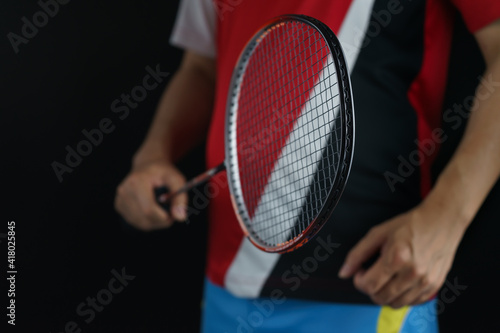 A badminton player postures receiving a badminton ball in a competition © Chaiya
