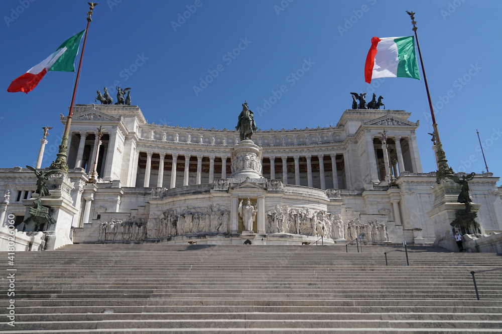 Piazza Venezia with grand marble Altar of the Fatherland with Italian flag, famous tourist landmark, guided tour concept, Rome, Italy