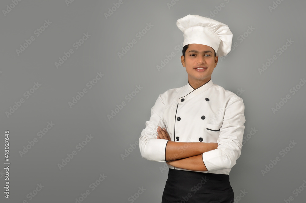 Happy male Indian chef Standing over grey background profession and people concept Happy male Indian chef Standing over grey background profession and people concept