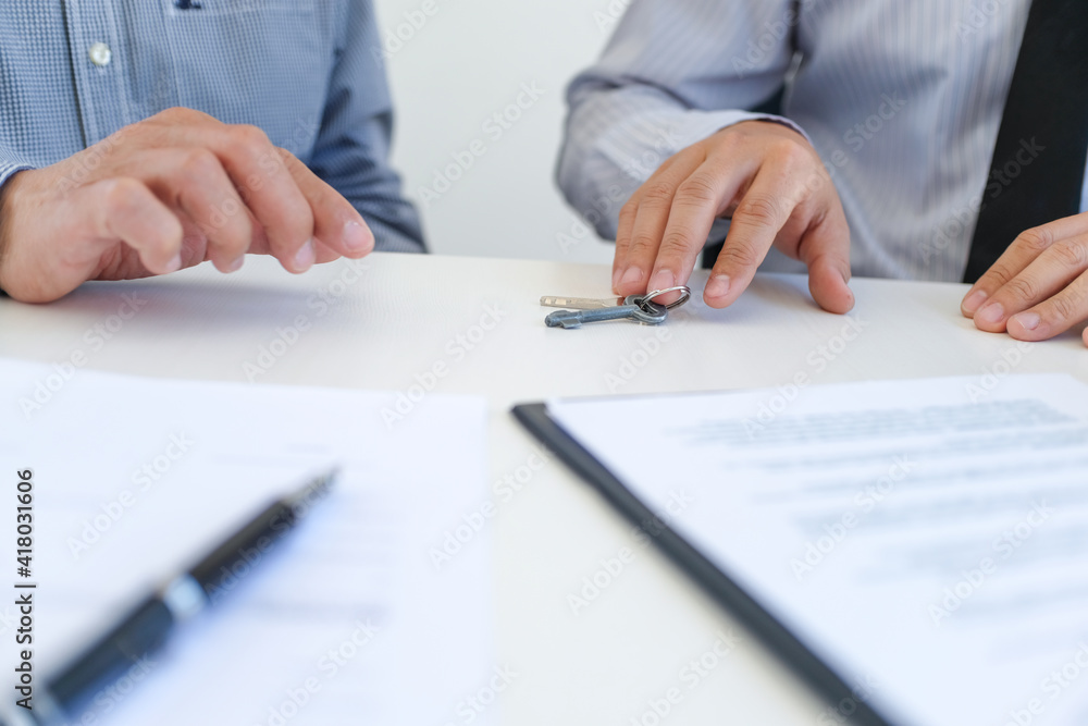 Sales manager giving advice application form document, considering mortgage loan offer for car and house insurance. Sales manager giving advice application form document, considering mortgage loan offer for car and house insurance.