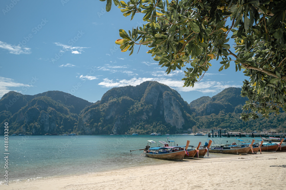 Fototapeta premium View long tail boat docking at harbor on Ton Sai Bay, Phi Phi Islands, Andaman Sea, Thailand.