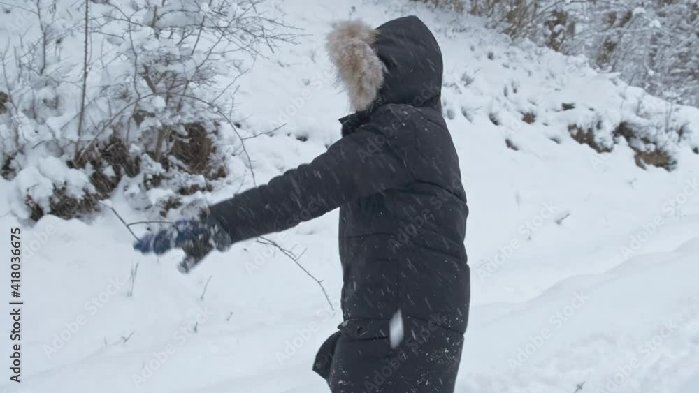 Boy having fun with snow in winter park with friends in vacation and holidays. Smiling child playing with snowballs outdoors. Emotion, happiness, lifestyle, mood concept. Boy having fun with snow in winter park with friends in vacation and holidays. Smiling child playing with snowballs outdoors. Emotion, happiness, lifestyle, mood concept.