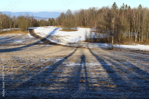 shadow figures in a mountain landscape at sunrise photo