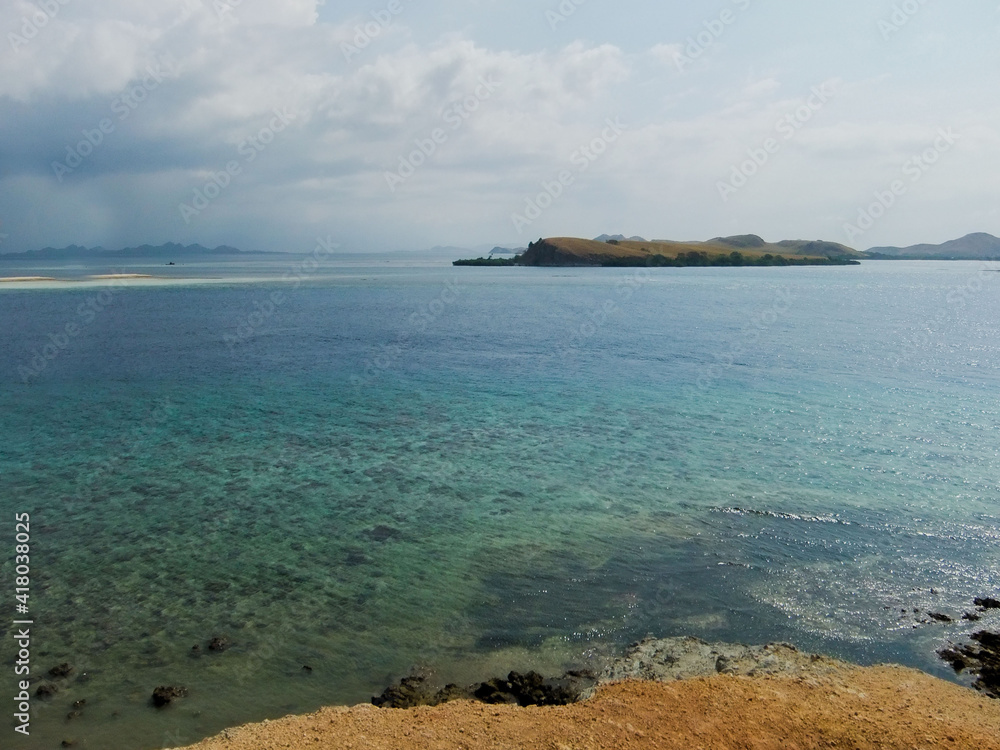 Stunning view, crystal clear blue water and white sand beach at Pulo Mesah Island Flores Indonesia