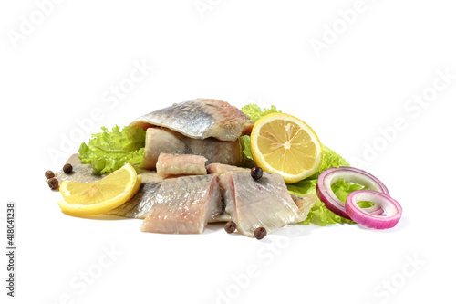 Atlantic salted herring fillet with onion ring,lemon, and pepper, isolated on a white background photo