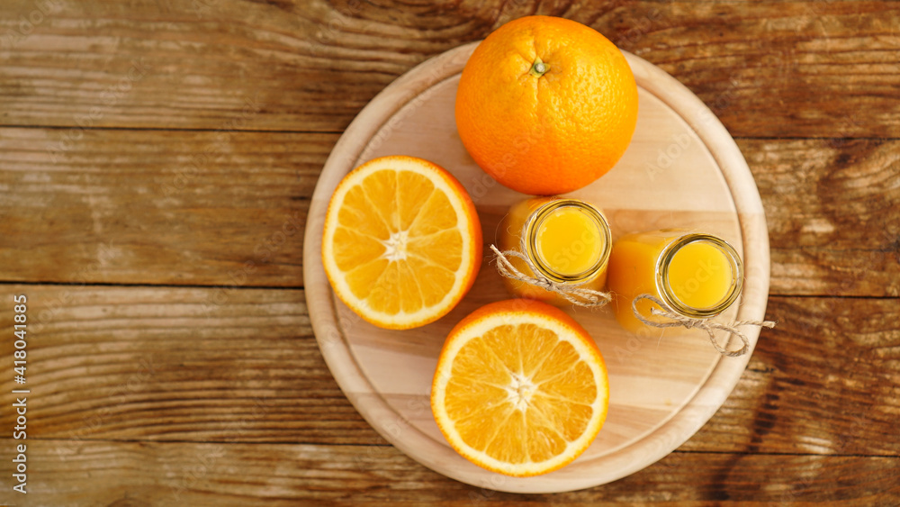 Fresh orange juice on wooden table on a wooden board Fresh orange juice on wooden table on a wooden board