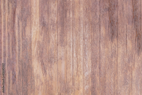 The texture of a polished wooden door, with a faded and worn surface.