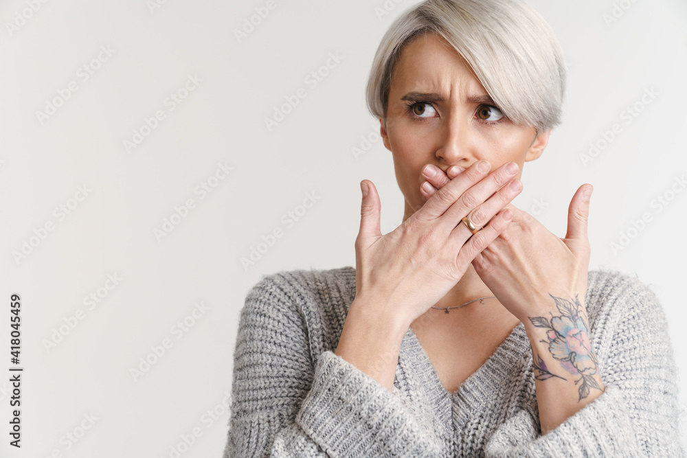 Displeased silver girl covering her mouth and looking aside Displeased silver girl covering her mouth and looking aside