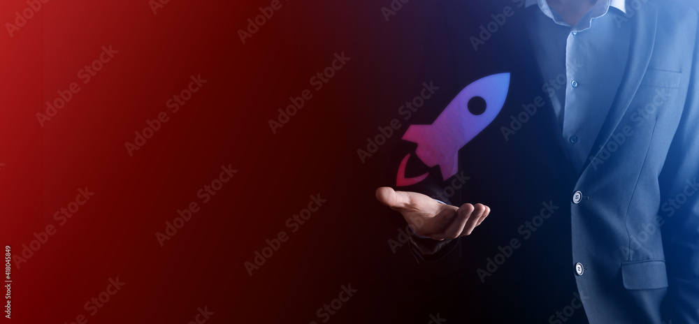 Startup business concept, Businessman holding tablet and icon rocket is launching and soar flying out from screen with network connection on dark background. Startup business concept, Businessman holding tablet and icon rocket is launching and soar flying out from screen with network connection on dark background.