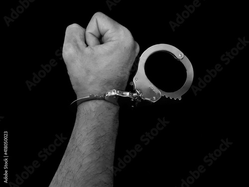 Handcuffs on arrested man hand, man loss freedom photo