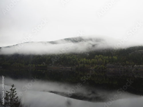 Gloomy landscape with fog on Norwegian fjords