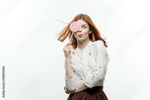 woman holding a round lollipop in her hands emotions sweets 