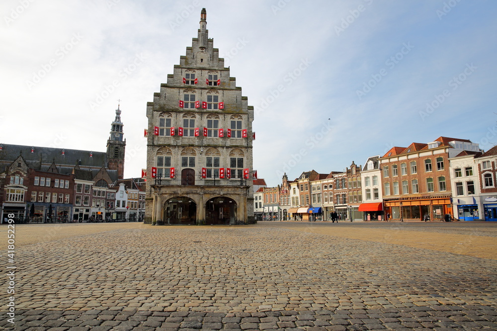 The impressive gothic styled Stadhuis (town hall, dated from 1450), located on the Markt (main Square) and with the clock tower of Sint Janskerk church in the background, Gouda, South_Holland, Netherl