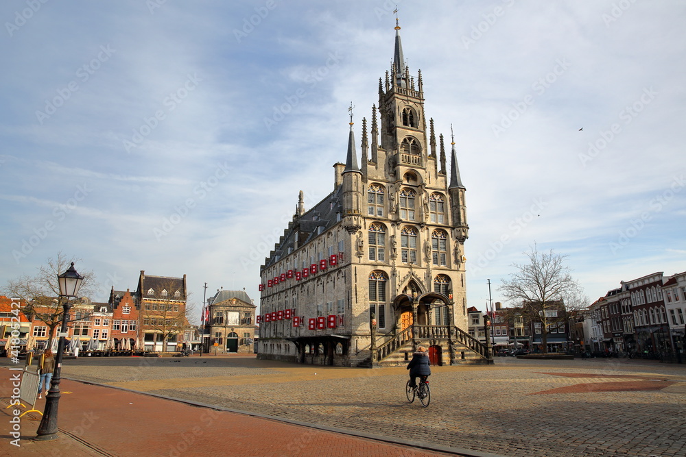 The impressive gothic styled Stadhuis (town hall, dated from 1450), located on the Markt (main Square), surrounded by historic houses in Gouda, South_Holland, Netherlands