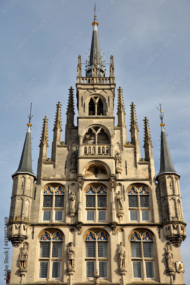 Close-up on the impressive gothic styled Stadhuis (town hall, dated from 1450), located on the Markt (main Square), with details of the carvings and turrets, Gouda, South_Holland, Netherlands