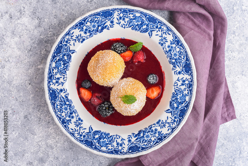 Sweet dumplings with berry sauce and fresh berries