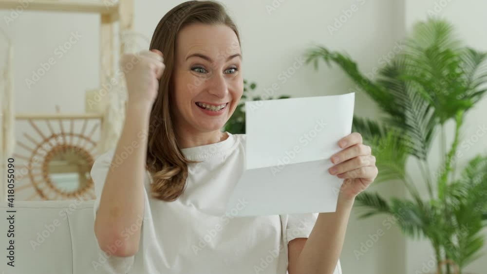 Happy brunette woman reading good news in letter, bank statement Happy brunette woman reading good news in letter, bank statement
