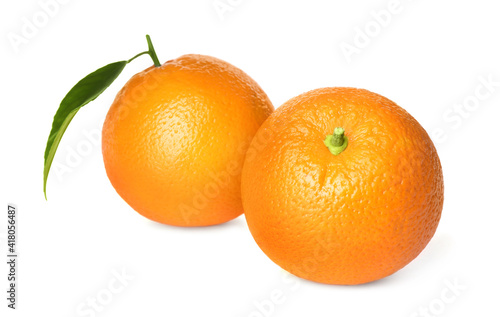 Fresh ripe oranges with green leaf on white background