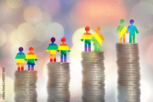 Love is love lGBT lesbian gay bisexual transgender rainbow model on stack of coins on colorful bokeh background. Making money with saving concept and return on investment roi idea