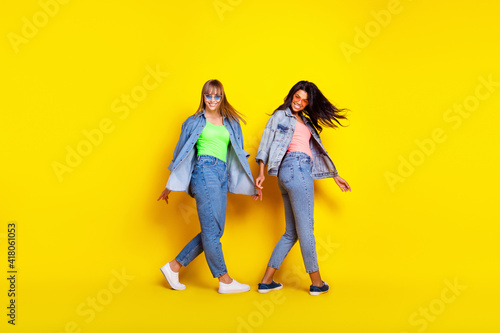 Full size profile portrait of two charming cheerful persons diversity toothy smile isolated on yellow color background