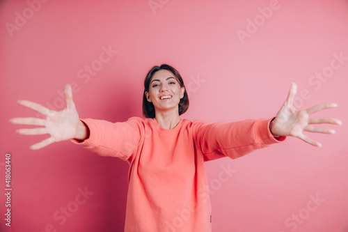 Woman wearing casual sweater on background looking at the camera smiling with open arms for hug