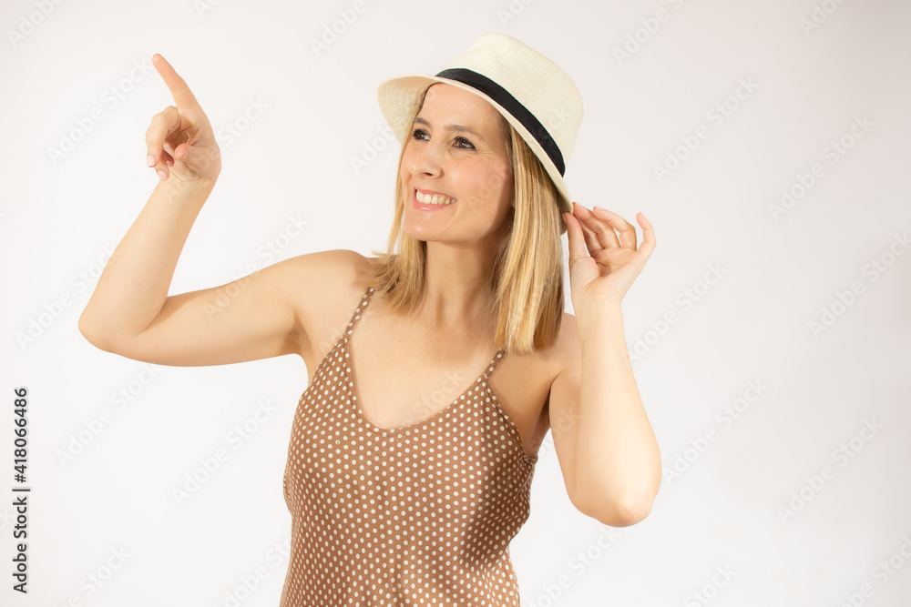 Portrait of beautiful young woman wearing straw hat pointing up over white background. Portrait of beautiful young woman wearing straw hat pointing up over white background.