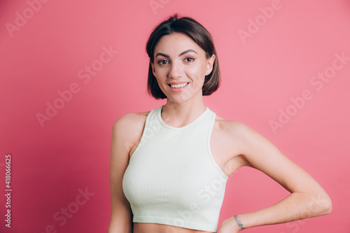 Woman on pink background  happy face smiling looking at the camera. Positive person.